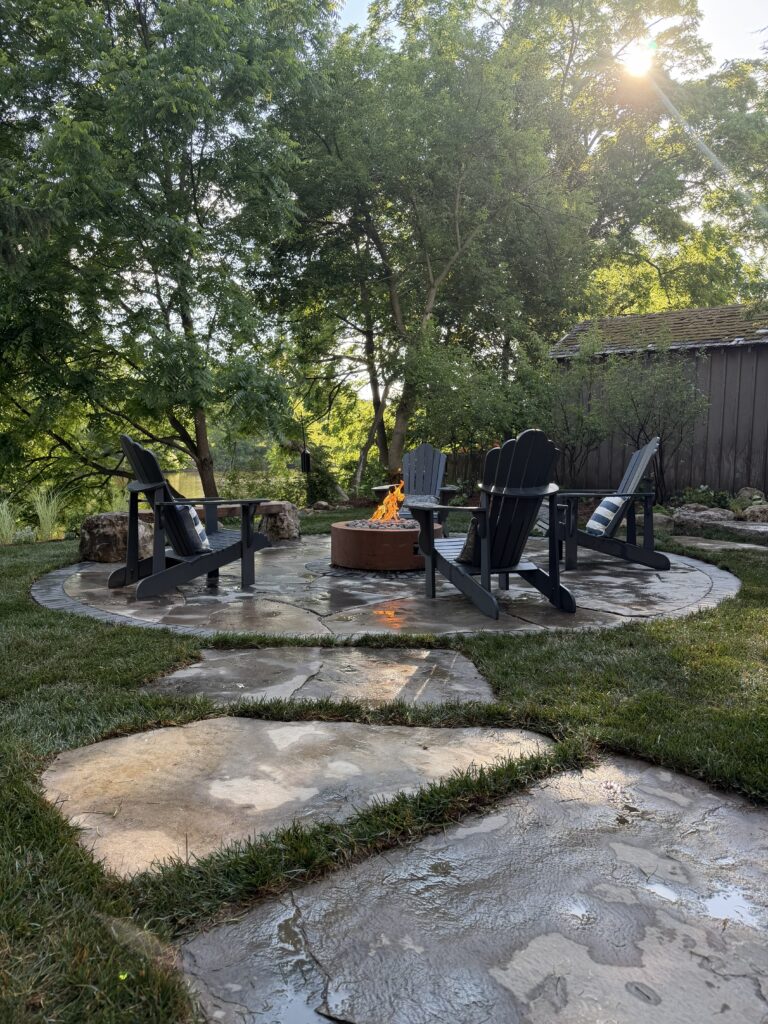 Handcrafted flagstone pad with gardens and firepit along the riverbank